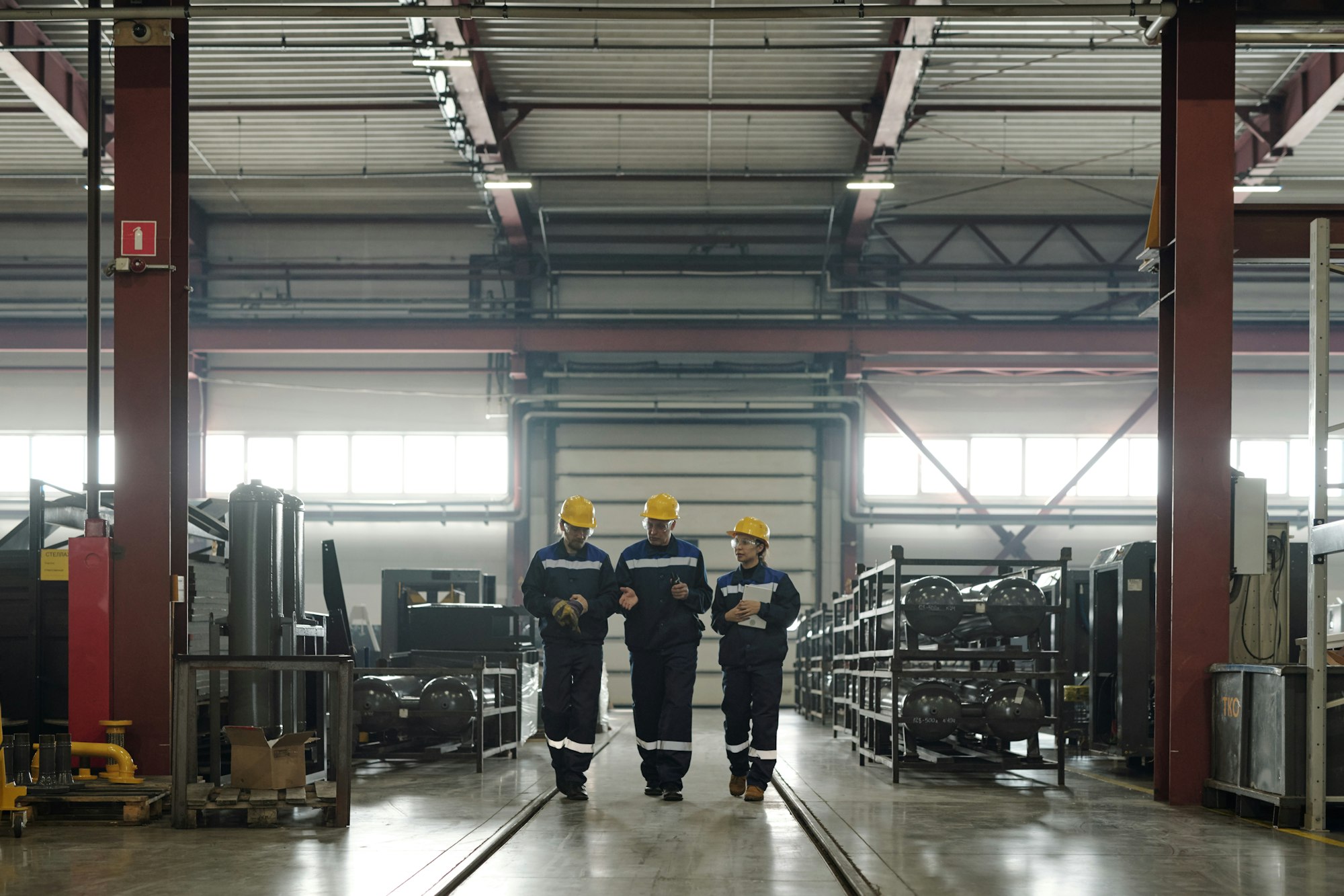 Plant workers discussing production of air compressors